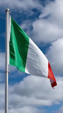 Italy flag waving in the wind against a bright blue sky, vertical video featuring realistic fabric motion, national pride and patriotic Italian atmosphere