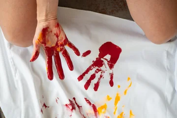 Creative shot of women's hands in multicolored paints on a white fabric. Art artist © Evgeny Leontiev