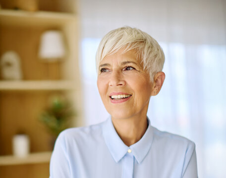 Portrait of an active senior elderly businesswoman during a meeting in the office
