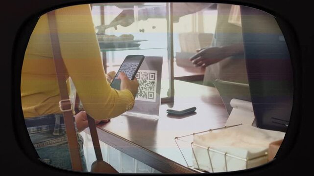 Female customer scanning QR code at bakery while male server grabbing pastry with tongs for pickup