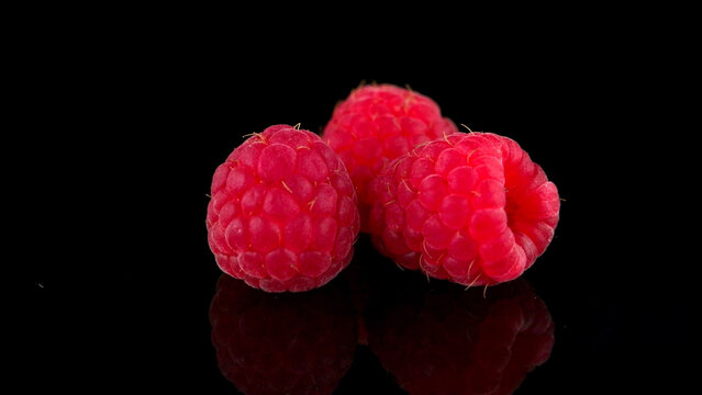 Raspberries isolated on black background