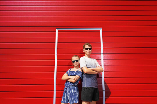 children on the red wall. The interaction of the children. Colorful concept focusing on children.