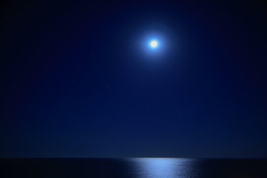 night sky with stars and moon over the sea