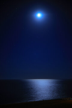 night sky with stars and moon over the sea