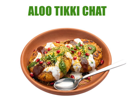 Traditional Aloo Tikki Chaat street food with potato patties topped with yogurt and tamarind chutney