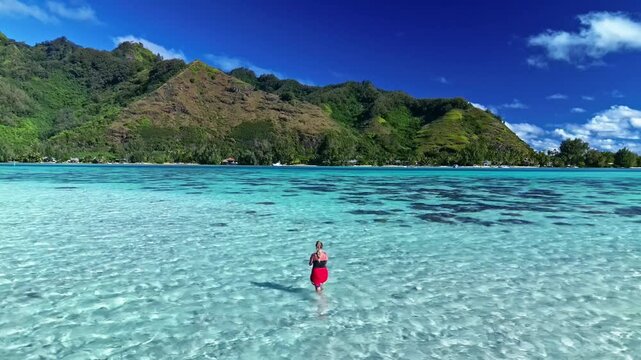 Woman snorkeling in a tropical turquoise lagoon in bora bora