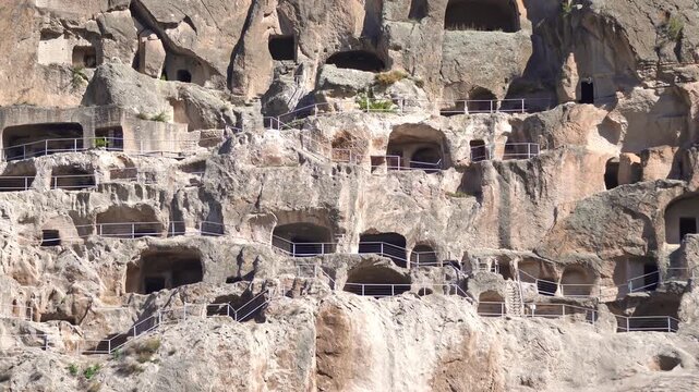 Vardzia, a historic cave monastery, displaying multiple levels of ancient rock-cut dwellings and terraces, offering a glimpse into medieval architecture and religious life in Georgia