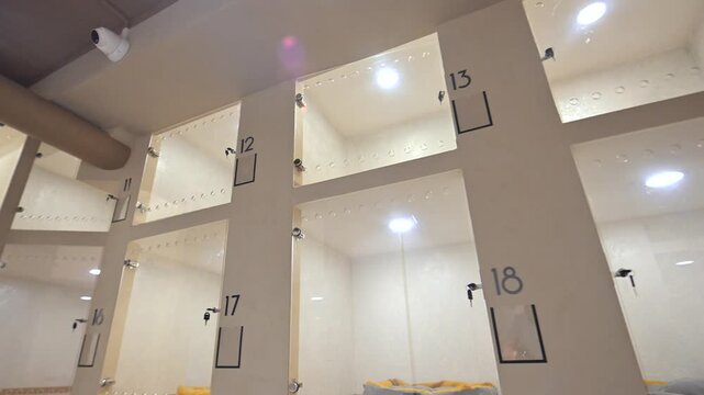 An empty pet boarding facility with individual rooms with glass doors.