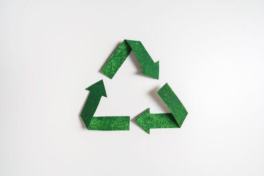 Green recycling symbol isolated on white background, sustainability and environmental conservation concept