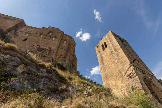Loarre, Spain. Low-angle view of the apse of the Romanesque church of San Pedro and the square albarrana tower at Castillo de Loarre, built and expanded by Sancho Ramirez in the 11th century. Huesca