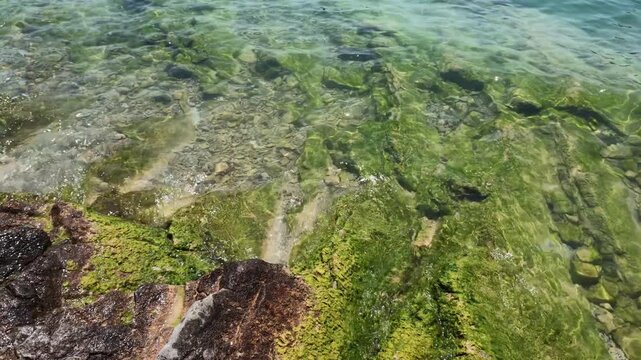 Waves on pebbles beach at Garda Lake, Bardolino, Italy