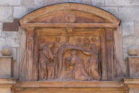 Alcala de Henares, Spain. Limestone relief depicting the Imposition of the Chasuble on Saint Ildefonsus, on the facade of the Capilla de San Ildefonso, carved circa 1599-1601 by Juan Ballesteros