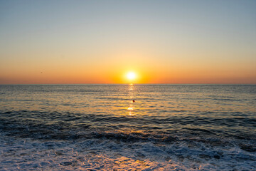 Obraz premium Beautiful sunset over the sea with wave. Evening sea landscape
