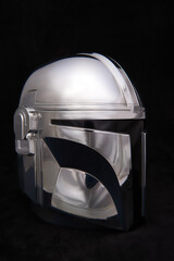 Obraz premium Professional photograph of a Mandalorean helmet on dark velvet, captured in El Salvador, Cinepolis on June 26, 2026.