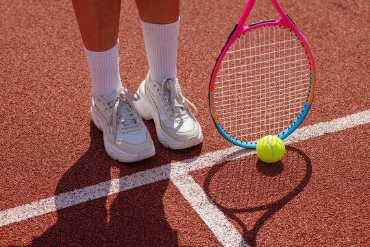 Women's Tennis Training Session with Racket and Ball on Court