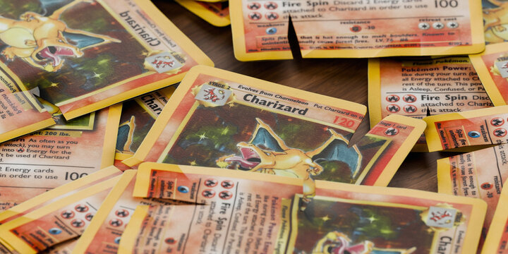 pile of worn and torn charizard base set pokemon cards, english tcg version