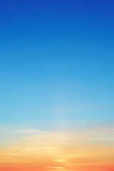 Obraz premium Clear morning sky background with warm orange and azure gradient shades. Scenic sunrise sky background banner showing dreamy concept and empty space for text.