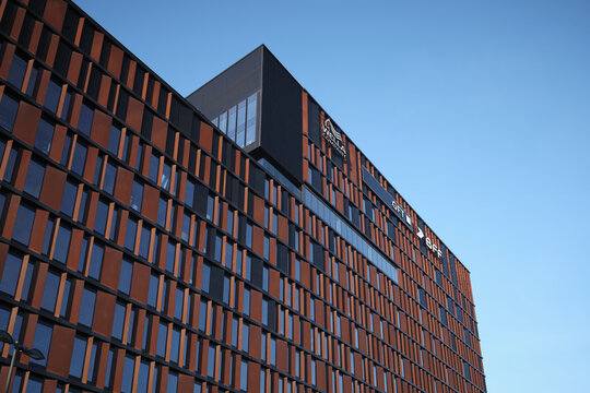 Modern Brama Miasta office building facade with Wella Company, GFT and BFF signage on April 12, 2026 in Lodz, Poland