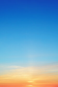 Clear morning sky background with warm orange and azure gradient shades. Scenic sunrise sky background banner showing dreamy concept and empty space for text.