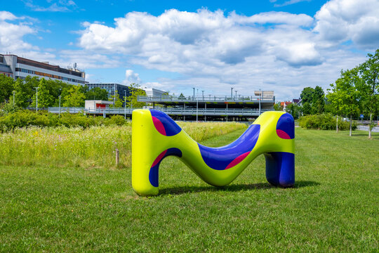 Merck KGaA colorful letter M sculpture, corporate logo pharmaceutical company Modern office headquarters building facade, biotechnology industry Contemporary office architecture, Darmstadt, Germany