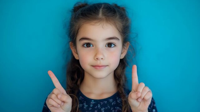 Young girl holding up a number