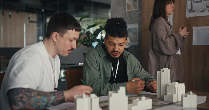 Team Reviewing an Architectural Model in a Modern Office