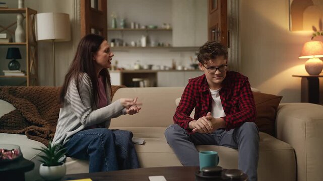 Annoyed mother scolding her teenage son for rebellious behavior, family conflict