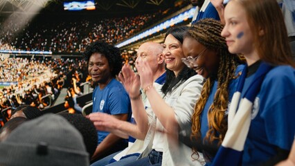 Soccer fans cheering and clapping during live football match, in stadium stands with football community. © DC Studio