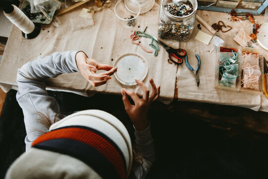 Child Making Beaded Jewelry