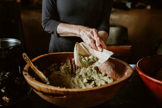 woman making food, tamales