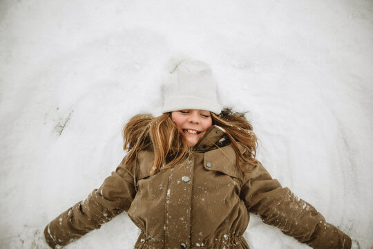 Little Girl Playing in Snow