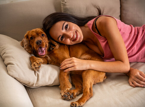 Woman Cuddling Dog.