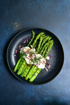 Grilled asparagus stalks with garlic sauce. Top view with copy space.