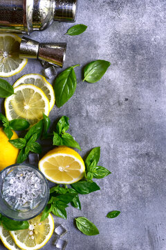 Ingredients fo making cold summer lemon and basil cocktail. Top view with copy space.