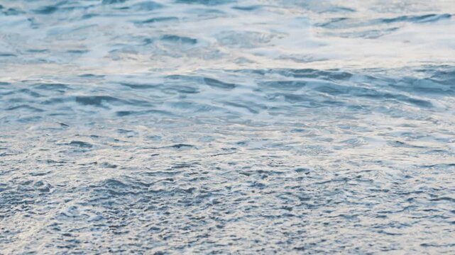 Soft abstract pattern of blue sea foam and rolling waves