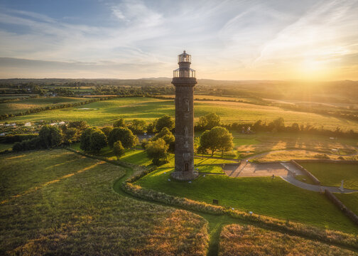 Aerial view of Spire of Lloyd surrounded by lush green fields and trees in County Meath, Ireland.