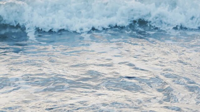 Close up abstract texture of foamy blue ocean waves