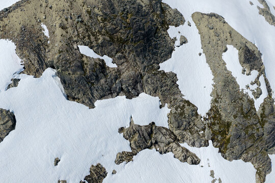 Aerial View of Rocky Alpine Snowfields and Granite Ridges in British Columbia, Canada