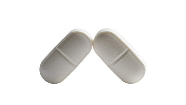 Isolated two oval white scored pharmaceutical pills for health, healing, and medical treatment