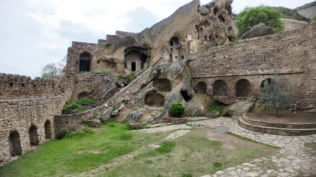 David Gareji monastery presenting its ancient rock-cut caves in Georgia. Stone structures. And historical architecture within the dry landscape