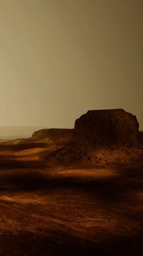 A vast rocky landscape is seen on Mars with hills and shadows from the sunset. The sky is clear and the orange and brown tones create an interesting scene.