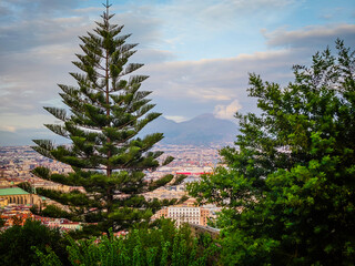 Fototapeta premium Aerial drone view of Naples old town panorama with Mount Vesuvius in background, scenic cityscape of historic center and iconic volcano view in Italy