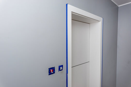 Interior room renovation work painting walls and door frame