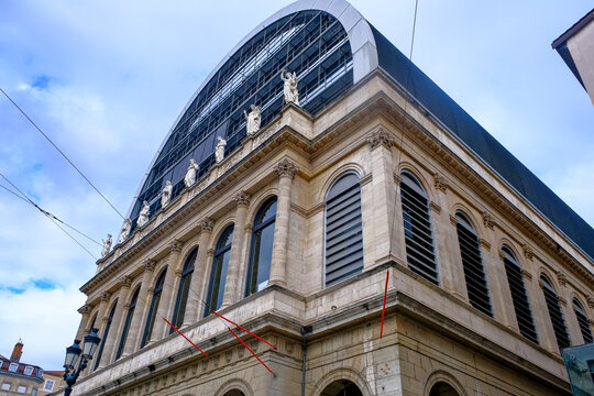 Lyon, France - 10.03.2026. A low-angle corner view of the Op&eacute;ra National de Lyon (Lyon Opera House) in France. The structure highlights a striking contrast of architectural styles, featuring the class