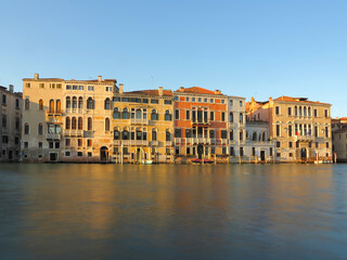 Obraz premium Historic colorful palazzos along Venice Grand Canal waterfront in warm evening light