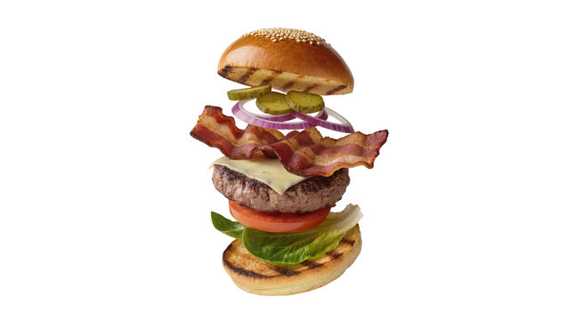 Isolated exploding bacon cheeseburger with fresh ingredients for a delicious meal