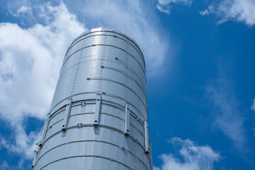 Metal grain silo against blue sky © Maxwell