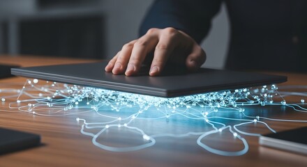 Naklejka premium Human Hand Interacting with Digital Network Data Stream Emerging from Beneath a Laptop Device on an Office Desk