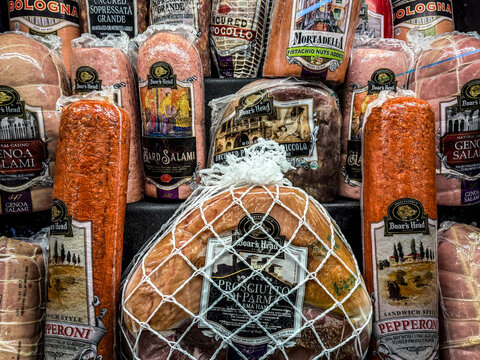 Mahwah, NJ - US - June 27 2026 Close-up display of assorted Italian deli meats including prosciutto, salami, mortadella and pepperoni, neatly stacked in packaging at a brightly lit grocery counter.