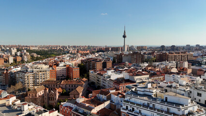 Obraz premium Drone photograph overlooking residential neighborhoods of Madrid with Torrespaña communications tower rising above the skyline